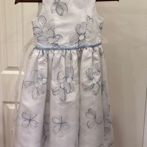 White dress with blue design and ribbon belt.